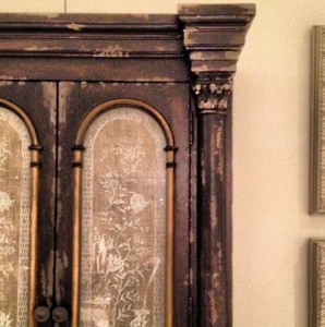 Unexpected Linen Detail on a Distressed Armoire from Hooker