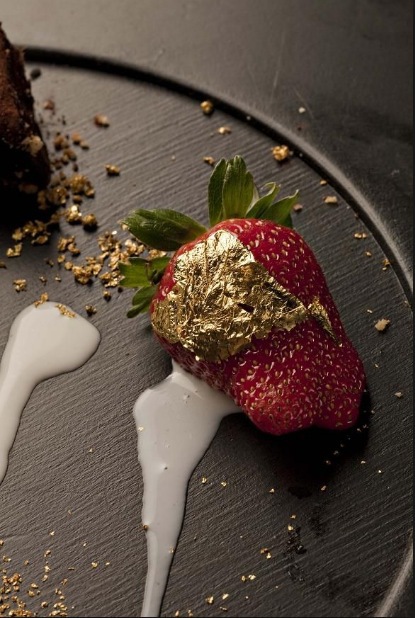 Pic of strawberry with edible gold flakes